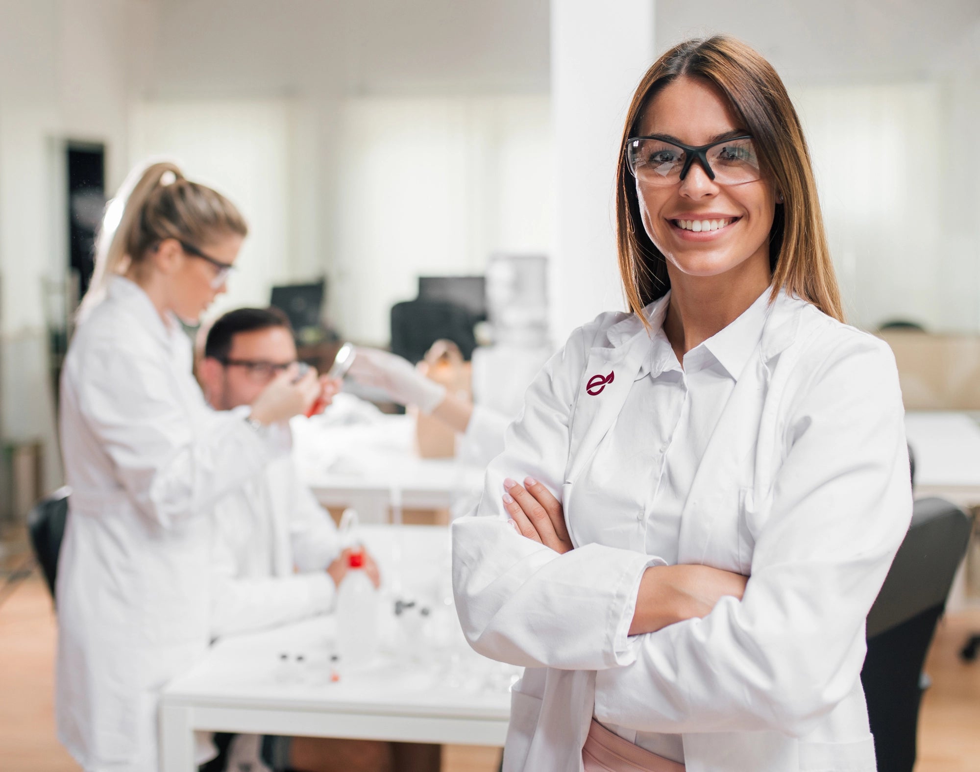 Team di ricerca in laboratorio: giovane professionista in primo piano, ambiente di lavoro dinamico e collaborativo.